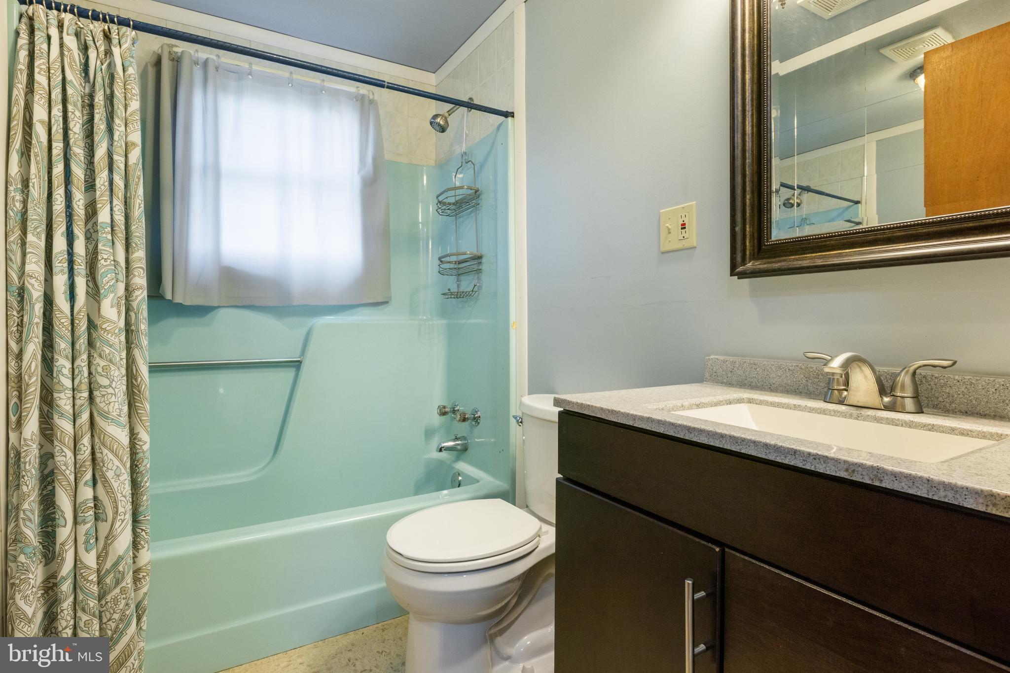 397 Sechrist Flat Road Felton, PA 17322 - Photo 12 of 44 a bathroom with a granite countertop sink toilet a mirror and shower
