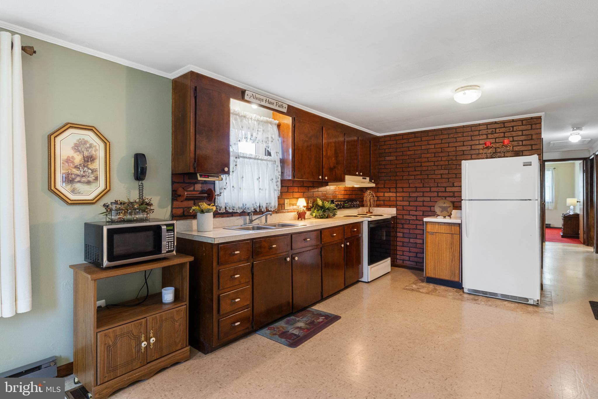 397 Sechrist Flat Road Felton, PA 17322 - Photo 8 of 44 a kitchen with refrigerator a microwave a stove and a refrigerator