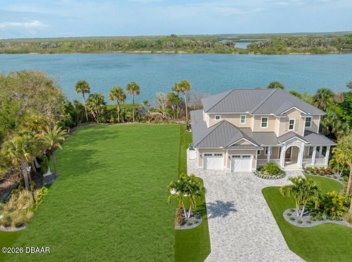 185 Jones Fish Camp Road Edgewater, FL 32141 - Photo 15 of 15 a front view of a house with a garden and lake view