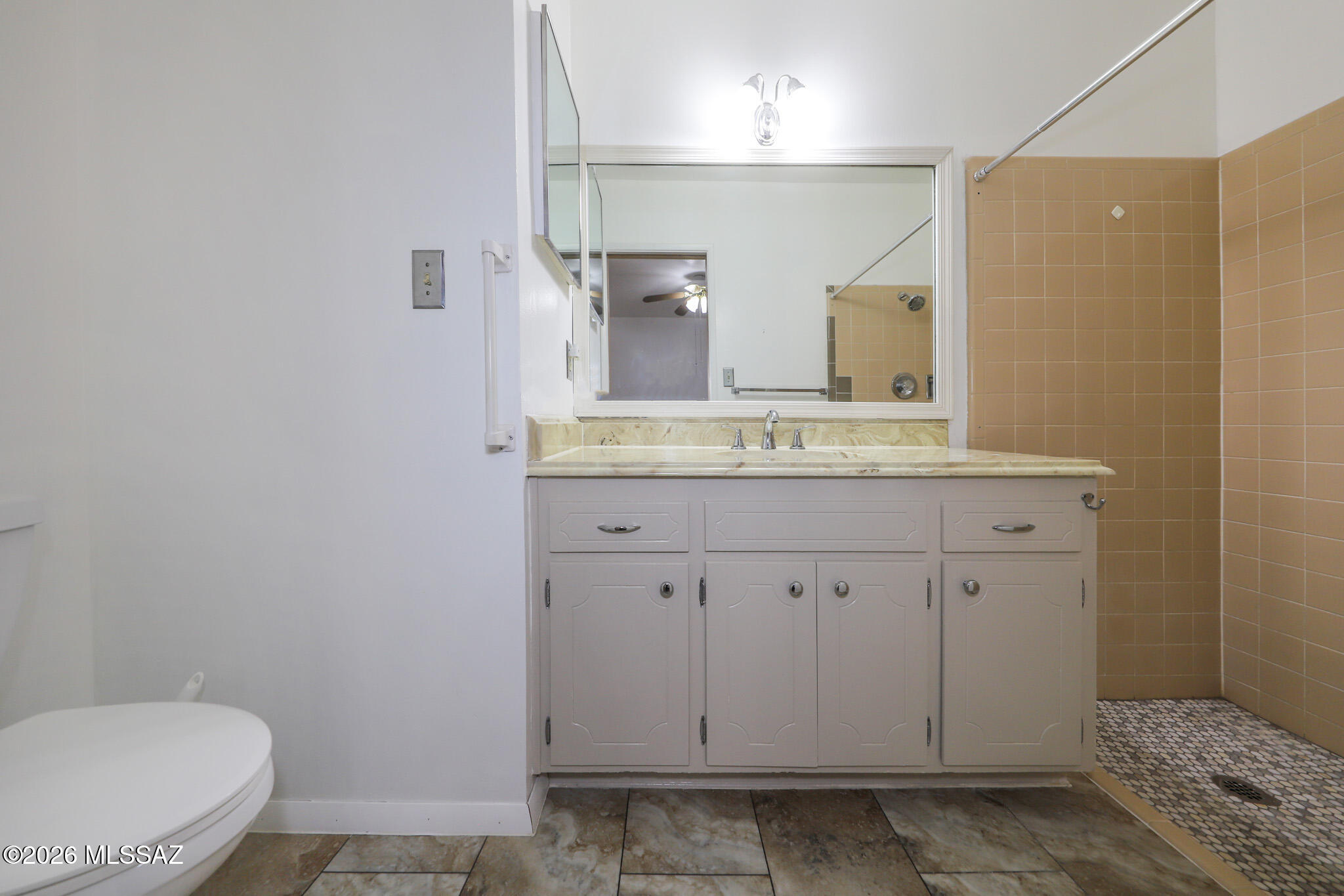 37 North Silverbell Road Tucson, AZ 85745 - Photo 18 of 31 a bathroom with a sink a toilet and mirror