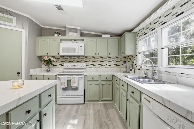 a kitchen with stainless steel appliances granite countertop a sink stove and cabinets