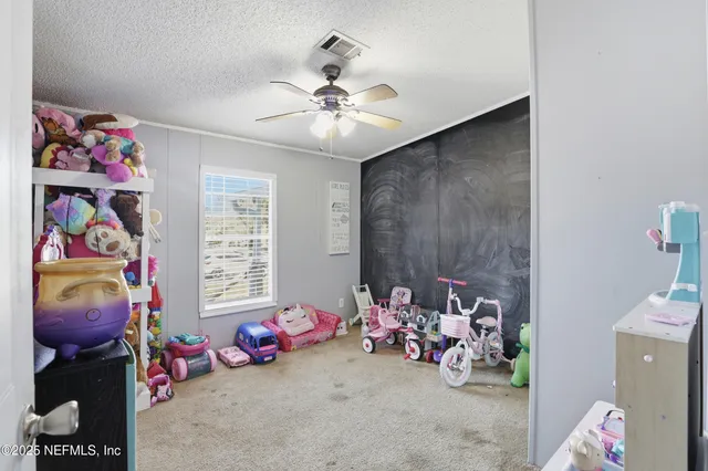 a view of a house with backyard and tree