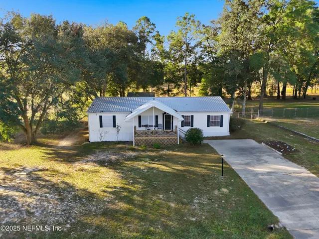 a view of a balcony with chairs and wooden floor