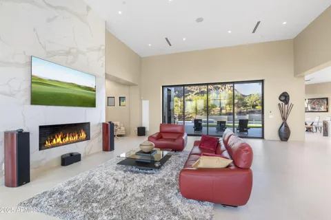 a dining room with furniture and large windows