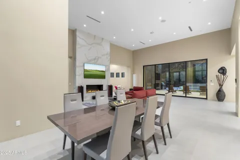 a dining room with furniture and a floor to ceiling window