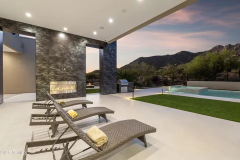 a large kitchen with stainless steel appliances a large counter top a stove and a refrigerator