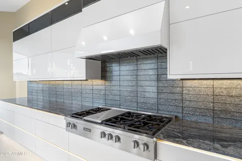 a spacious bathroom with a double vanity sink a mirror and a bathtub