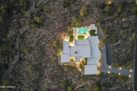 an aerial view of a house with a yard