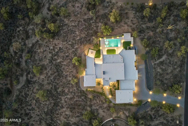 an aerial view of a house with a yard