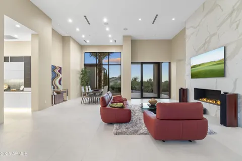 a living room with furniture and large windows