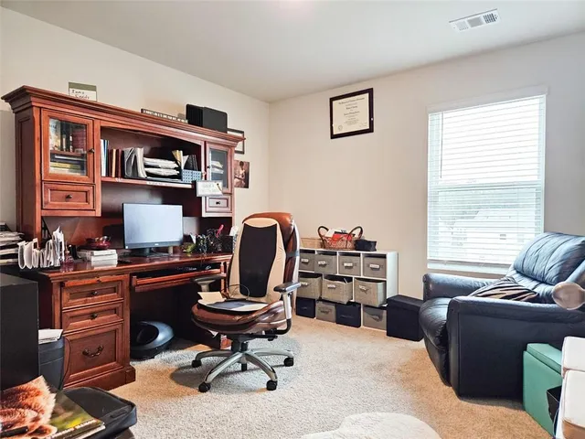 a living room with furniture window and a flat screen tv
