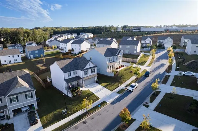 an aerial view of residential houses with outdoor space