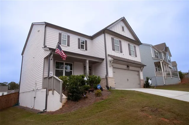a front view of a house with a yard and garage