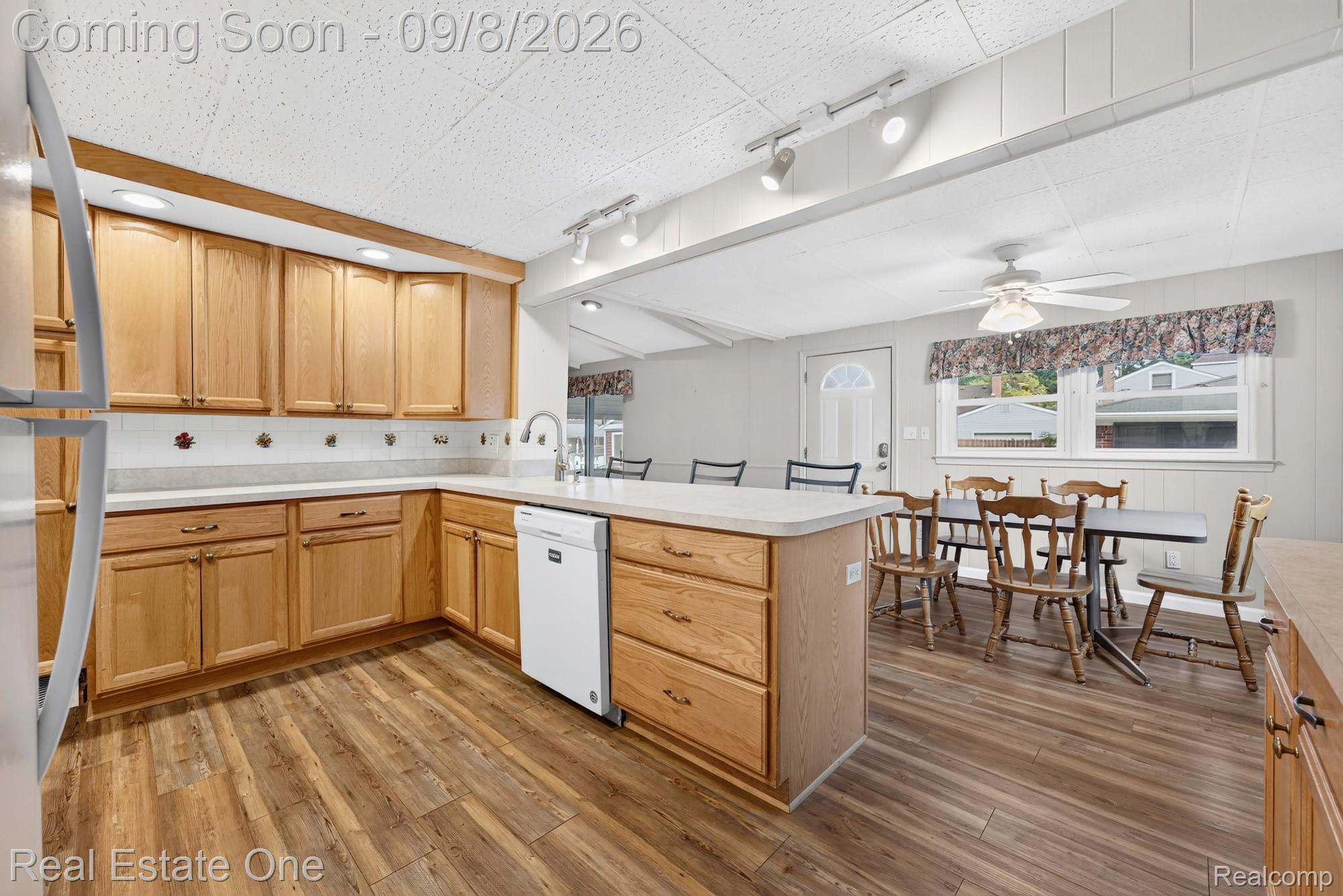7961 Merrick Street Taylor, MI 48180 - Photo 9 of 39 Kitchen featuring wood-finish flooring, light wood cabinetry, white countertops, and a white dishwasher
