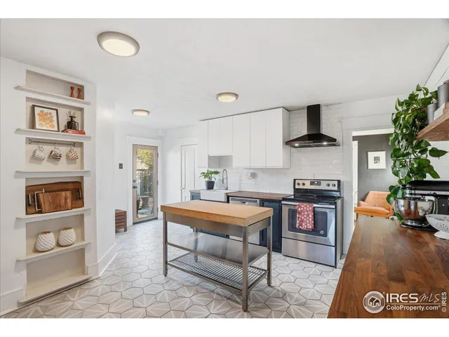 a sink with a potted plant on a counter