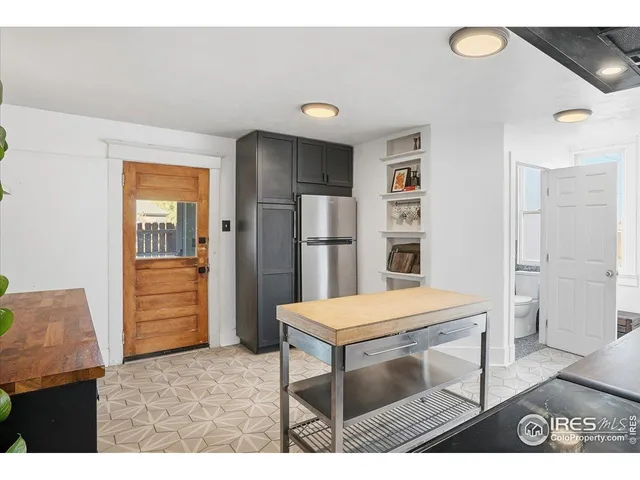 a bedroom with a bed next to a window with outer view
