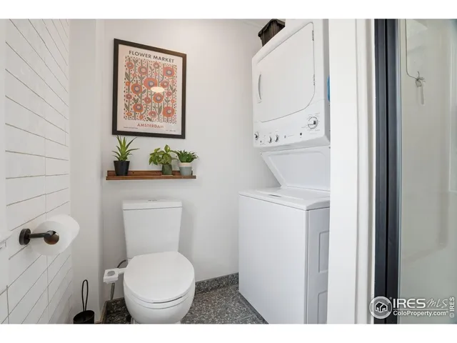 a view of a backyard with table and chairs under an umbrella