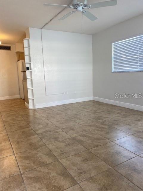 4565 Duhme Road, Unit 110 St. Petersburg, FL 33708 - Photo 3 of 13 a view of a livingroom with a ceiling fan and window