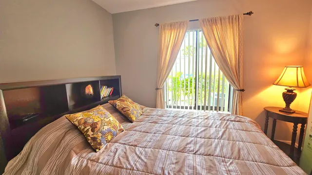 a bed sitting in a bedroom next to a window