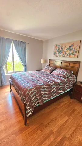 a bed sitting in a bedroom next to a window