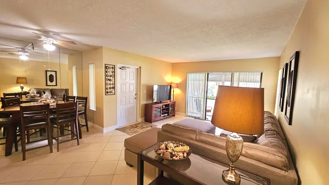 a bedroom with furniture and a large mirror