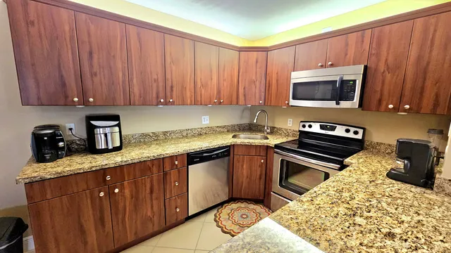 a kitchen with a sink stove and microwave