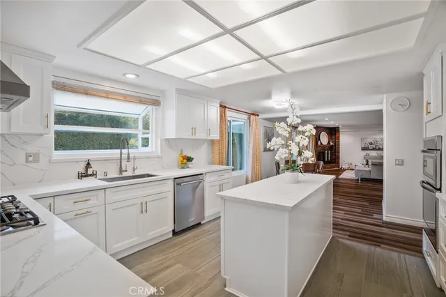 a kitchen with white cabinets and appliances