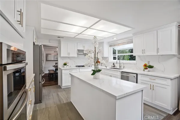 a kitchen with granite countertop white cabinets and white appliances