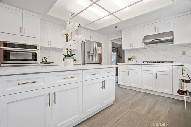 a kitchen with stainless steel appliances granite countertop a sink and cabinets