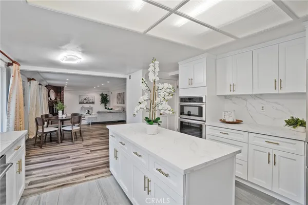 a view of a a dining room with furniture window and wooden floor