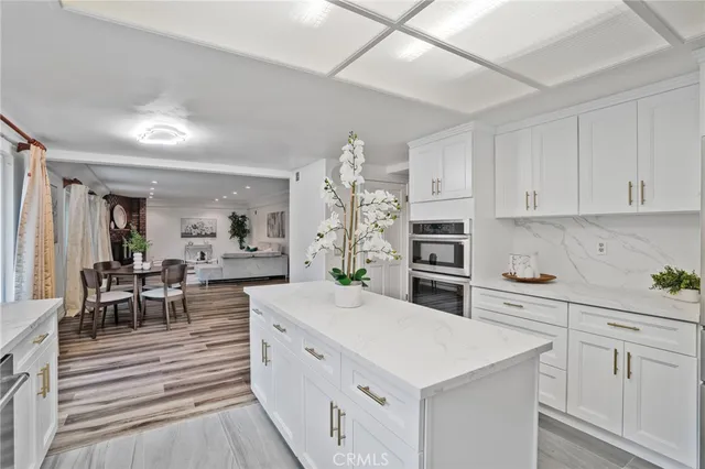 a view of a a dining room with furniture window and wooden floor