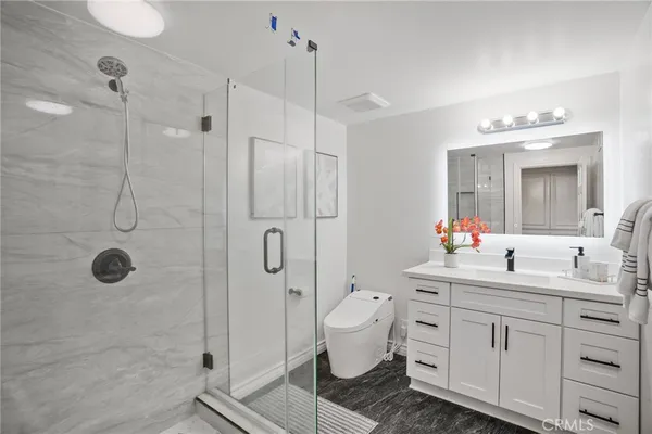 a view of a room with wooden floor and natural light