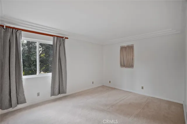 an empty room with windows and city view