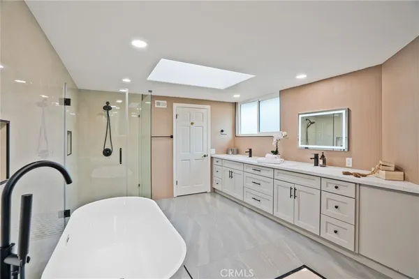 a bathroom with a bathtub and shower