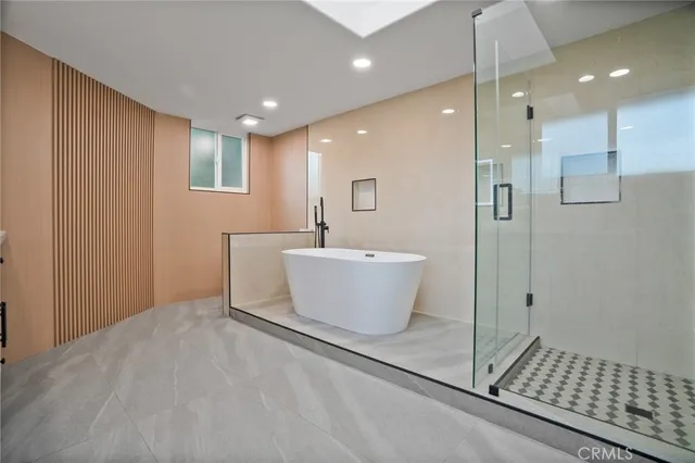 a bathroom with a double vanity sink a mirror and a bathtub