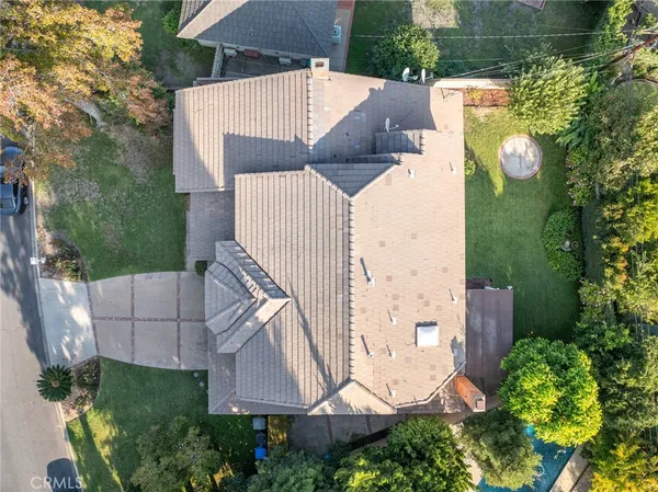 an aerial view of a house with a yard and balcony
