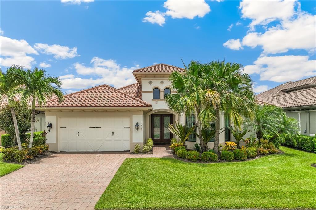 12449 Lockford Lane Naples, FL 34120 - Photo 1 of 45 a view of a white house with a big yard and potted plants