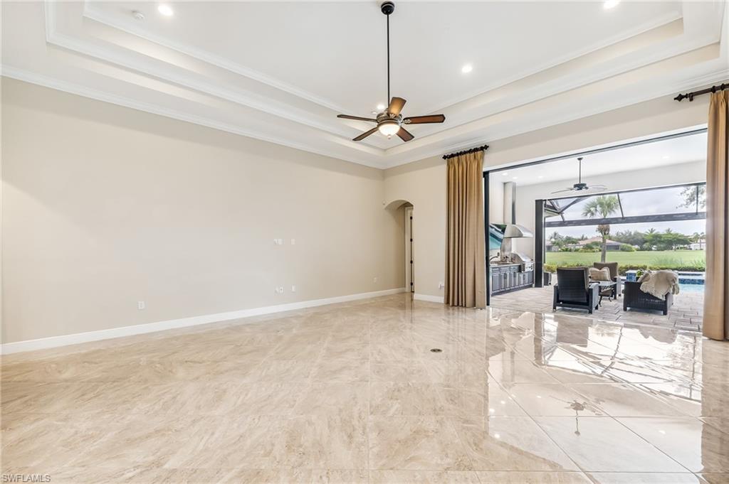 12449 Lockford Lane Naples, FL 34120 - Photo 11 of 45 a view of a livingroom with a chandelier furniture and a ceiling fan