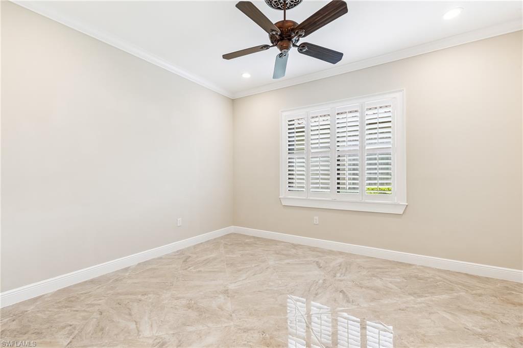 12449 Lockford Lane Naples, FL 34120 - Photo 13 of 45 a view of a big room with windows and chandelier fan