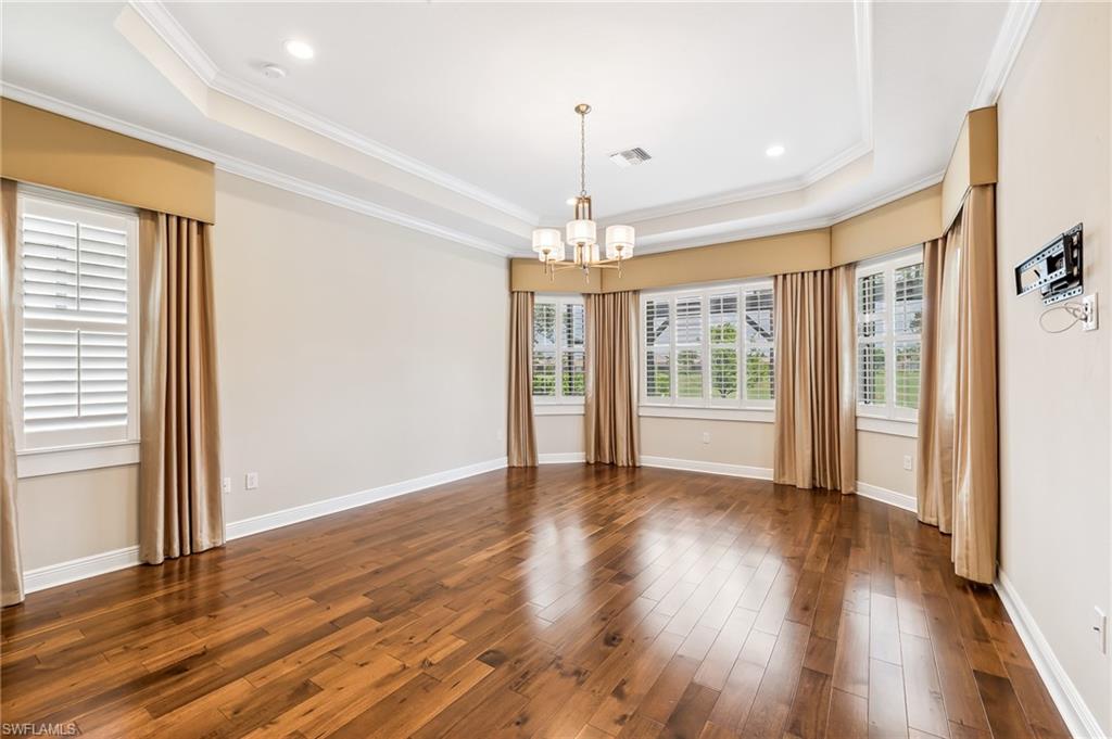 12449 Lockford Lane Naples, FL 34120 - Photo 15 of 45 a view of an empty room with wooden floor and a window