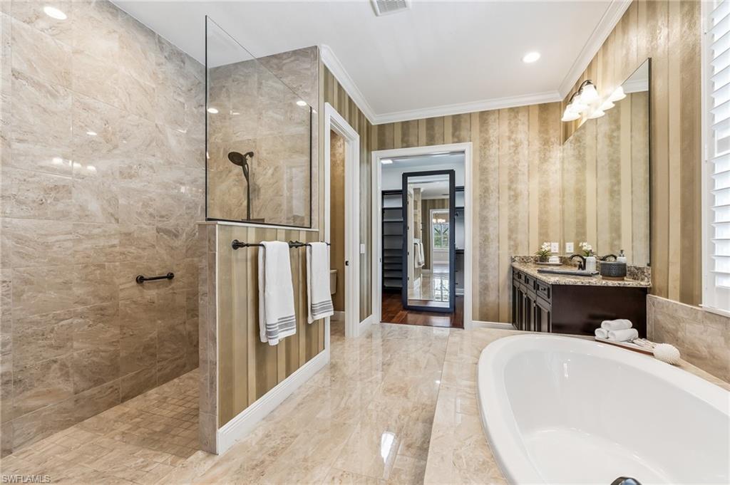 12449 Lockford Lane Naples, FL 34120 - Photo 18 of 45 a spacious bathroom with a tub shower and sink