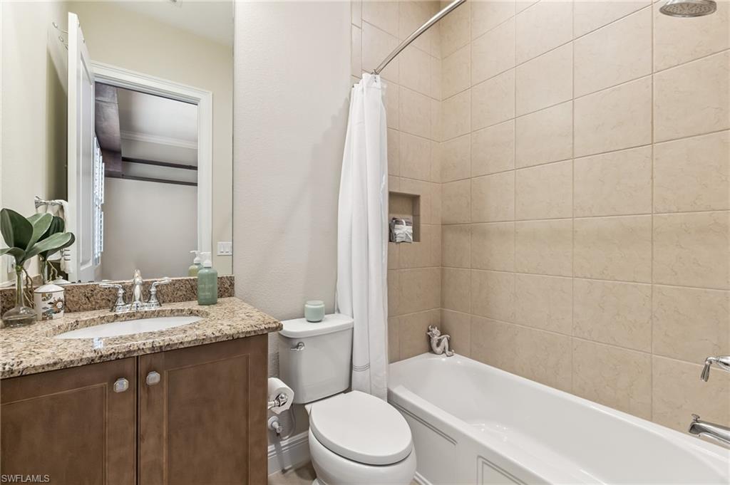 12449 Lockford Lane Naples, FL 34120 - Photo 21 of 45 a bathroom with a sink a toilet and shower