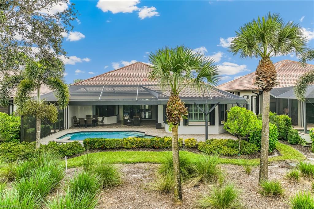12449 Lockford Lane Naples, FL 34120 - Photo 29 of 45 a front view of house with yard and outdoor seating