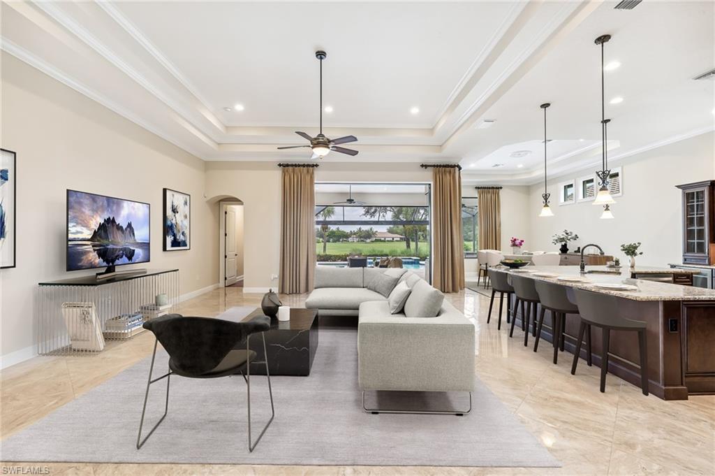 12449 Lockford Lane Naples, FL 34120 - Photo 3 of 45 a living room with lots of furniture and view of kitchen