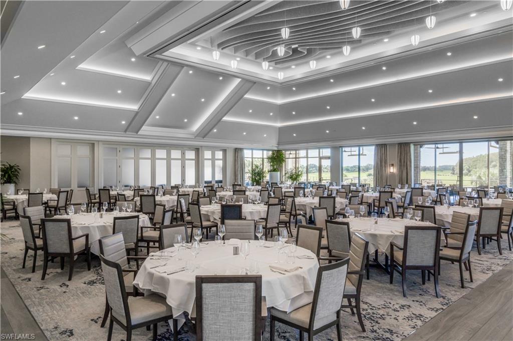 12449 Lockford Lane Naples, FL 34120 - Photo 35 of 45 a room with lots of tables a large window and chairs