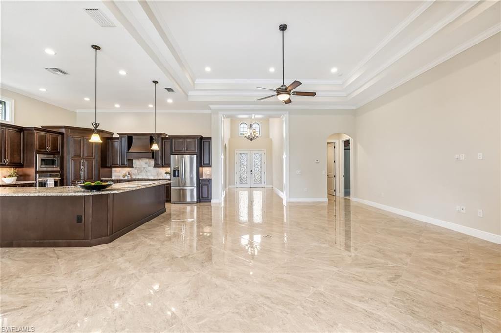 12449 Lockford Lane Naples, FL 34120 - Photo 8 of 45 a large kitchen with a large counter top appliances and cabinets