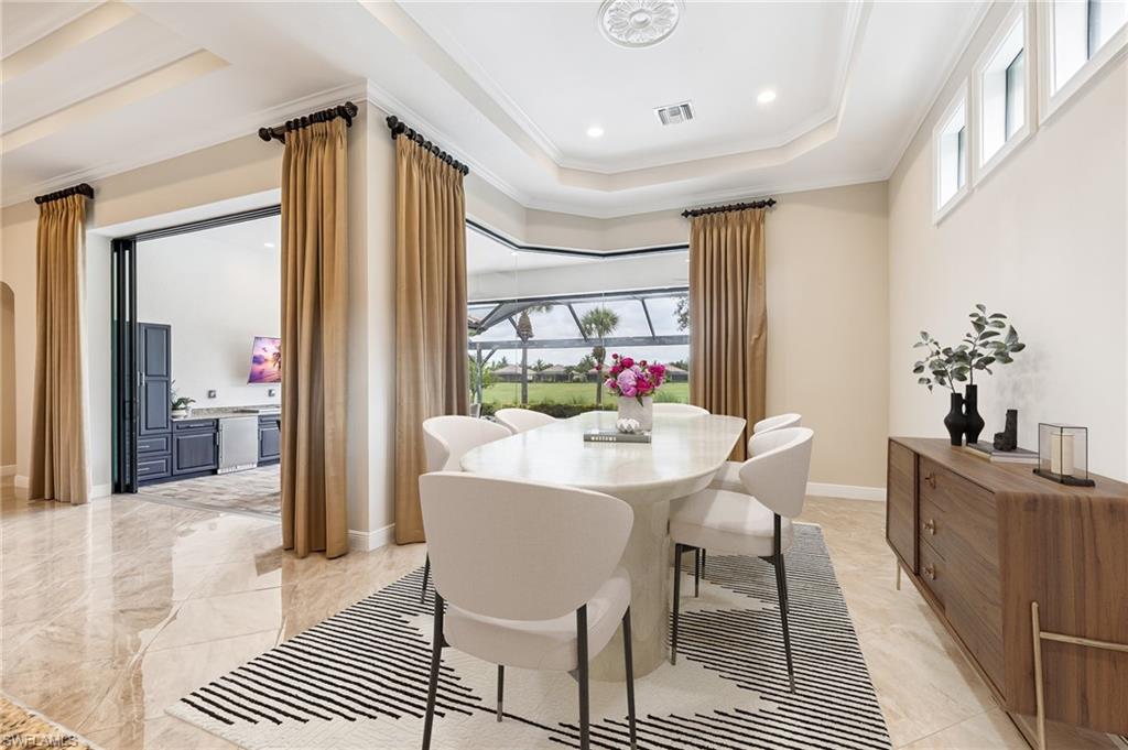12449 Lockford Lane Naples, FL 34120 - Photo 9 of 45 a view of a dining room with furniture window and wooden floor