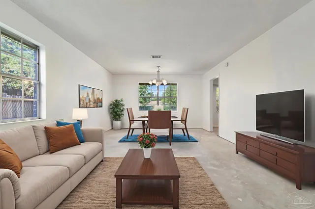 a living room with furniture and a flat screen tv