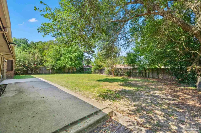 an aerial view of a house with a yard and lake view