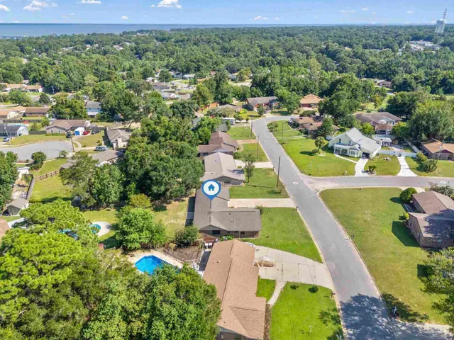 an aerial view of residential houses with outdoor space and swimming pool